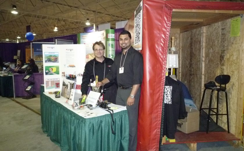 treb show, two men smiling in front of green and white table