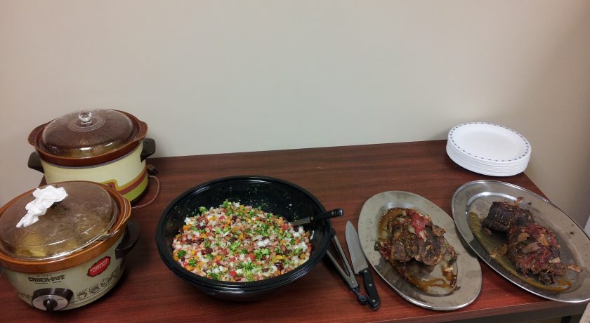 two brown and white pots, black bowl with colourful chopped vegetables, two silver plates with food on a brown table