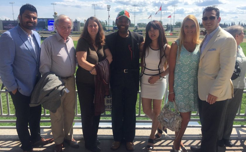 Woodbine Races, group of 8 people taking a picture in front of the race track