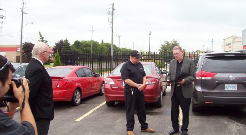 4 men in a parking lot at the 25 Year Anniversary for Brantford General Manager