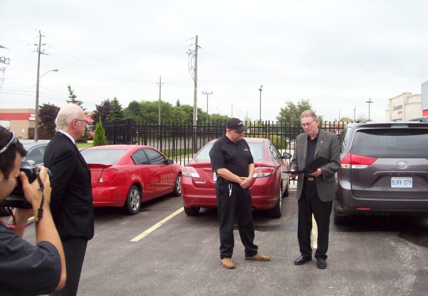 4 men in a parking lot at the 25 Year Anniversary for Brantford General Manager