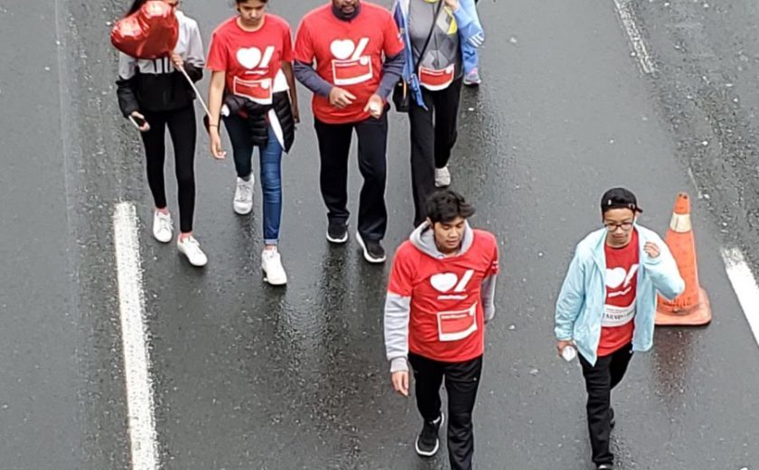 XYZ storage team wearing grey, yellow, and red walking on the highway