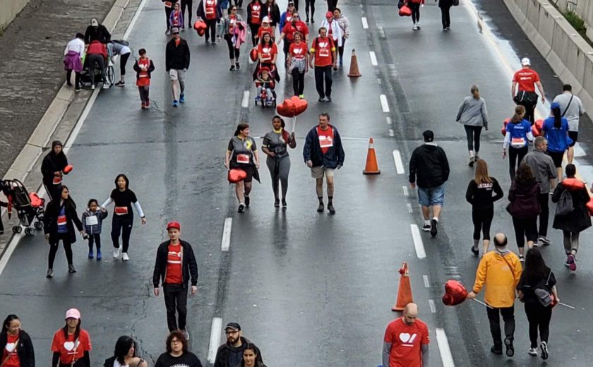 people walking on the highway including XYZ storage team wearing grey, yellow, and red