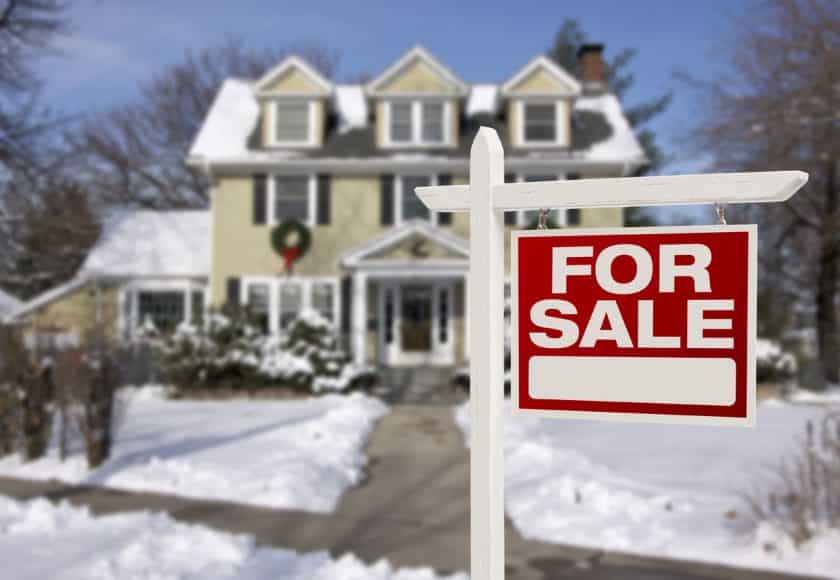 Home For Sale Sign in Front of Snowy New House