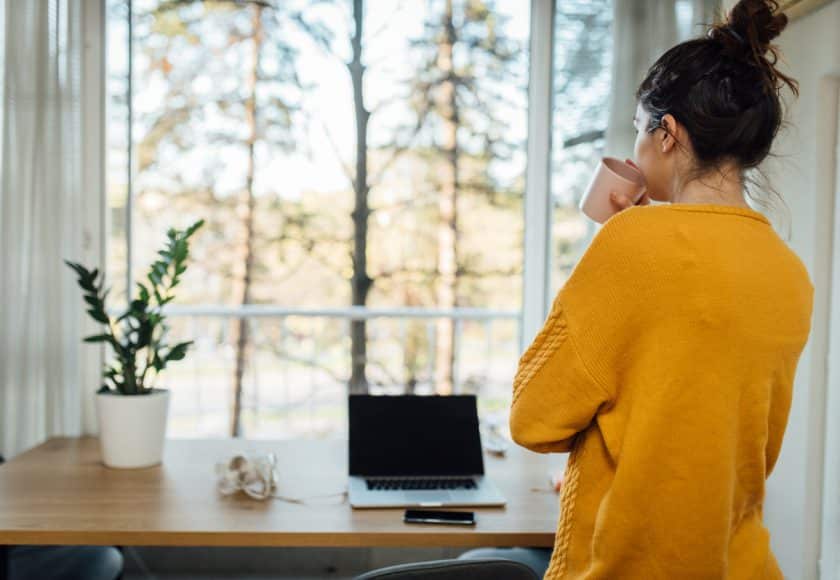 Young woman taking a break at her home office during the quarantine due to Covid-19.