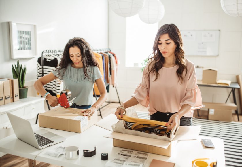 Working women at their store. They wearing casual clothing and accepting new orders online