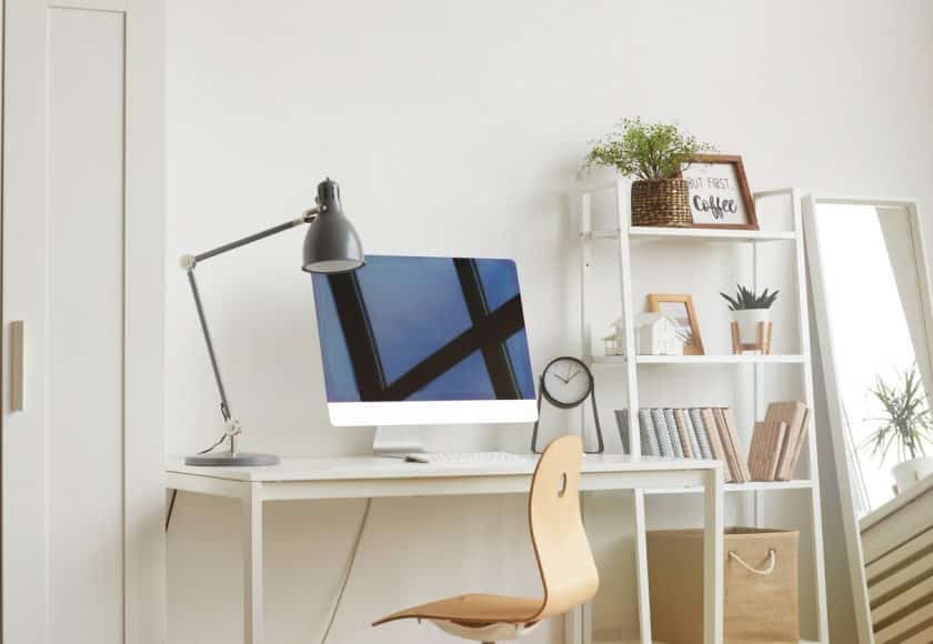 White Background image of empty home office workplace with wooden chair and modern computer on white desk, copy space